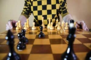 Man in background playing chess