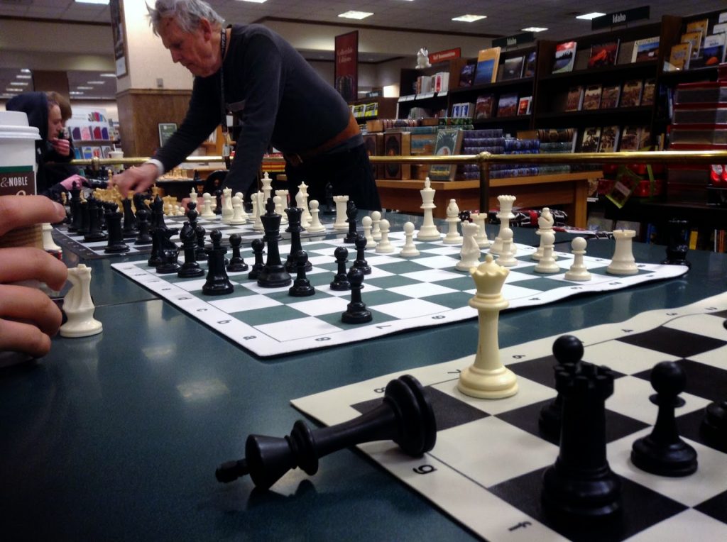 Man playing multiple opponents in a simultaneous exhibition