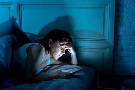 woman looking at her phone in the night