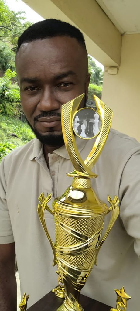 AGM Chinedu Enemchukwu, The First National Chess Champion Of St. Vincent And The Grenadines holding his trophy