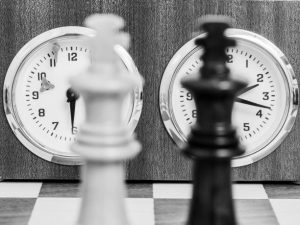 Chess pieces in front of a chess clock