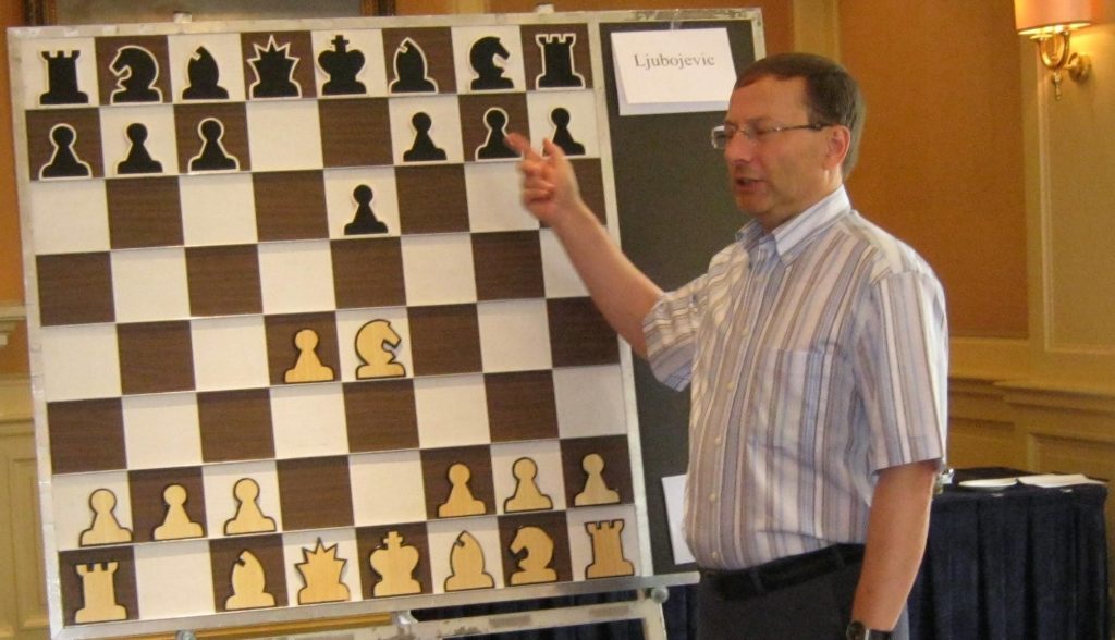 Man coaching chess with demonstration board