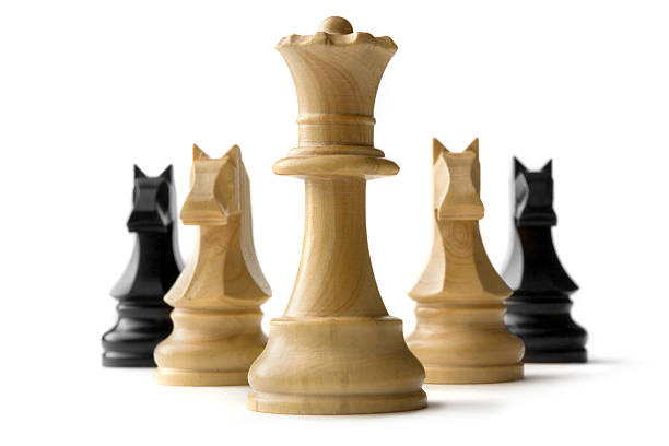 White queen chess piece with two white knights chess piece and black knights chess piece at its rear.