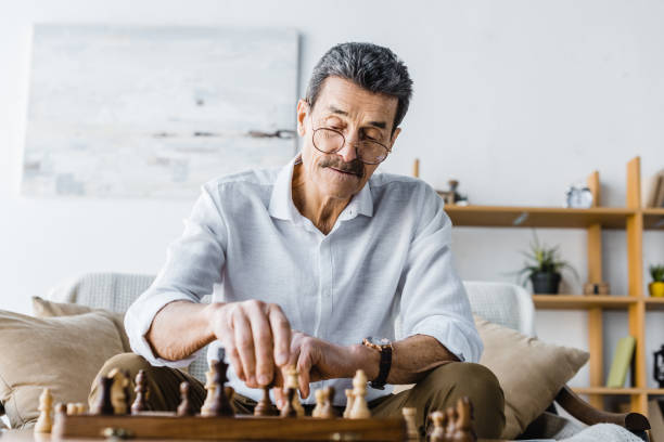 Older man playing a game of chess