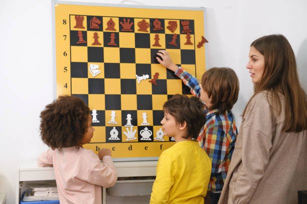 Child Thinking Hard On Chess Combinations on the wall on tournament for kids