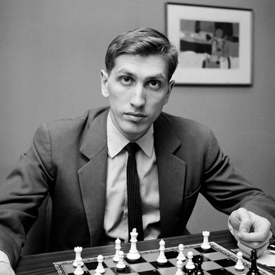 Bobby Fischer sitting in front of a chess board