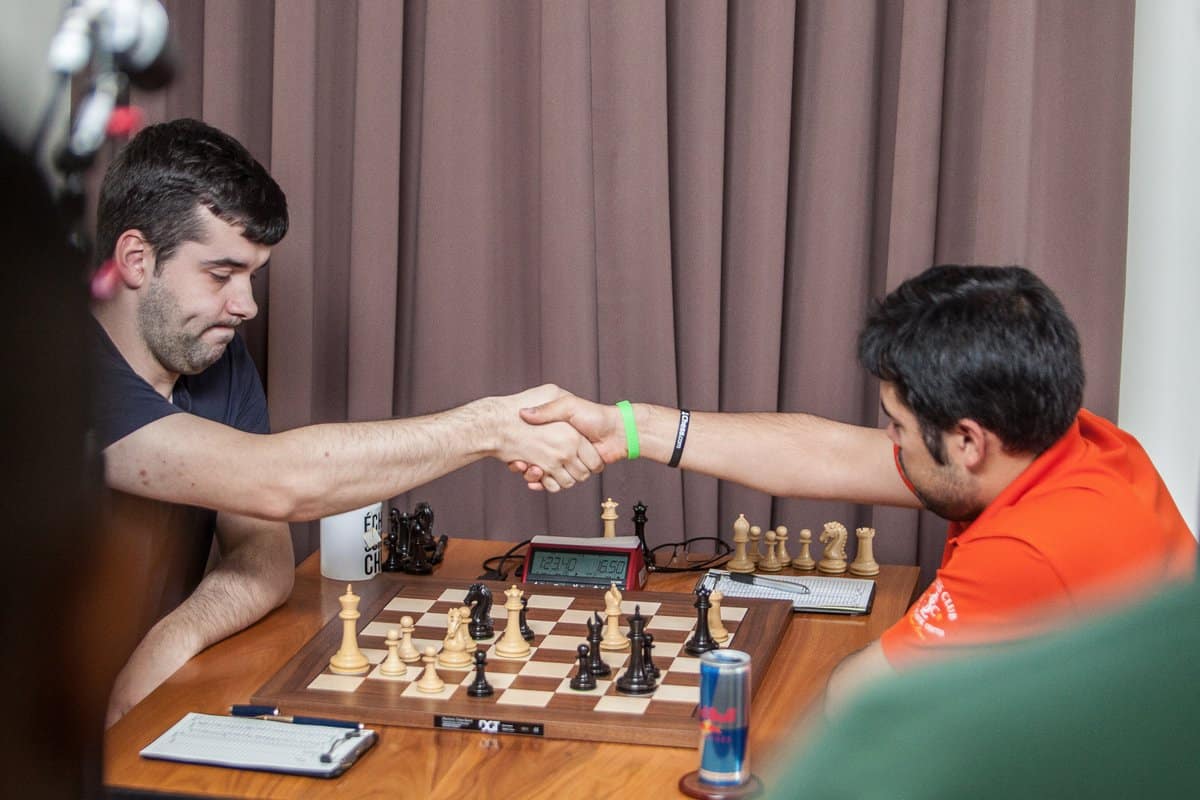 Two players shaking hands after playing a chess game