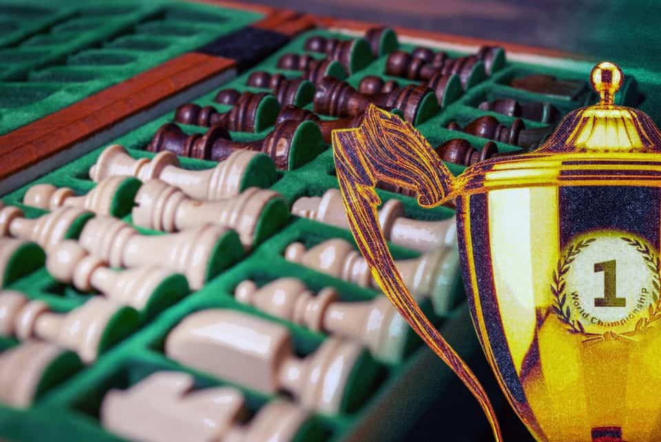 Picture showing chess pieces in a set, a world championship cup