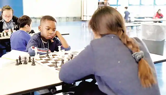 Young TANITOLUWA ADEWUMI with the white pieces during a game of chess.