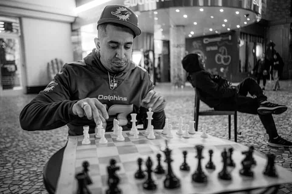 Man moving the white chess pieces
