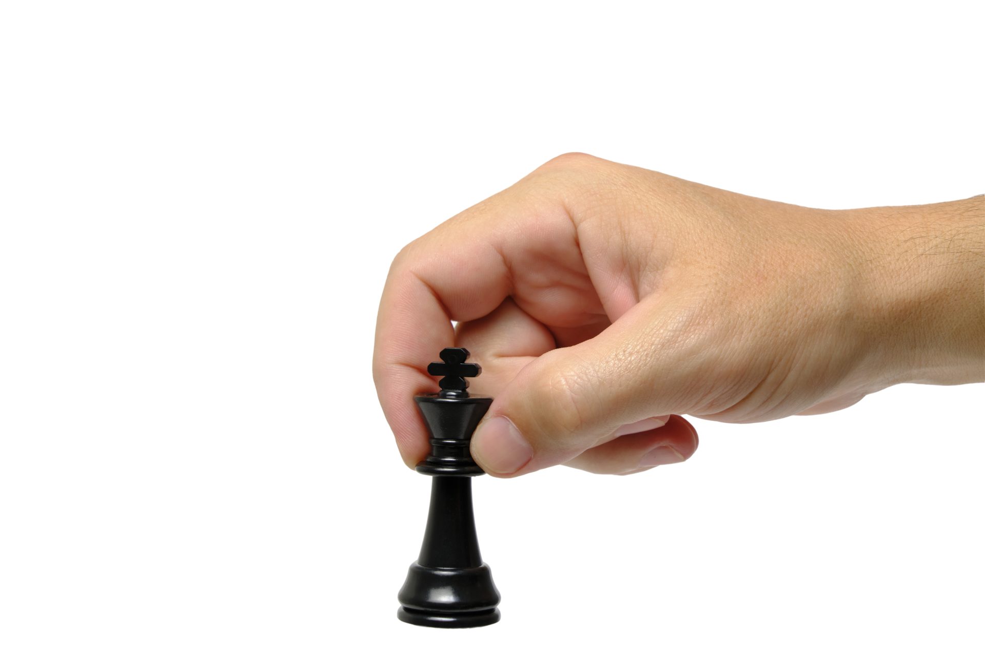 Black chess king in hand on a white background